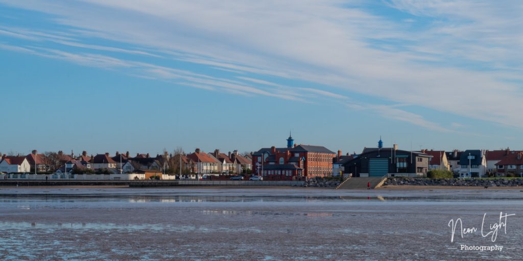 Looking towards the old Parade School and Lifeboat Station on Hoylake Promindade under a cold blue winters sky.